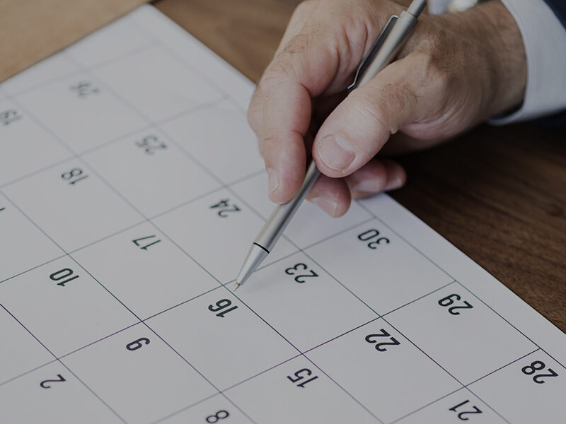 Businessman marking on calendar for an appointment Businessman Marking Calendar Photo