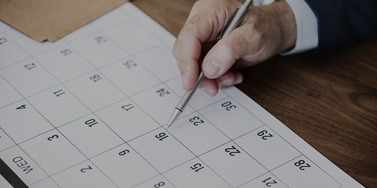 Businessman marking on calendar for an appointment Businessman Marking Calendar Photo